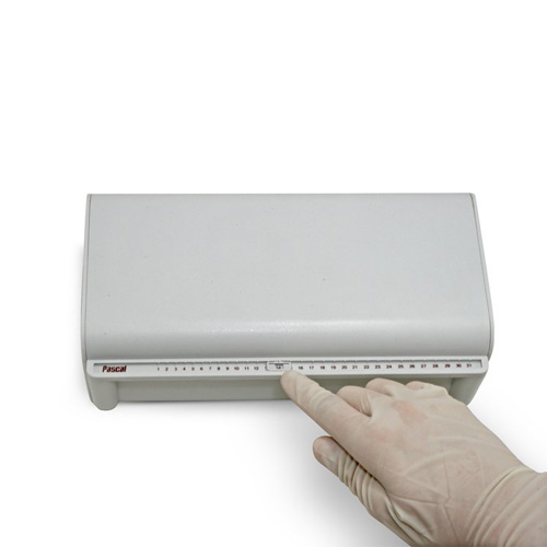 Dental professional using Tap & Slide® Tray with ergonomic handle and quick-drain deck for safe instrument disinfection